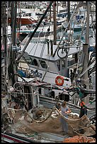 Man and woman repairing nets on fishing boat. Whittier, Alaska, USA