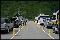 Cars and RVs lining up for the tunnel crossing. Whittier, Alaska, USA (color)