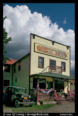 Ma Johnson hotel with classic car parked by, afternoon. McCarthy, Alaska, USA