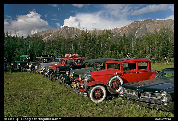 Vintage cars lined up in meadow. McCarthy, Alaska, USA (color)