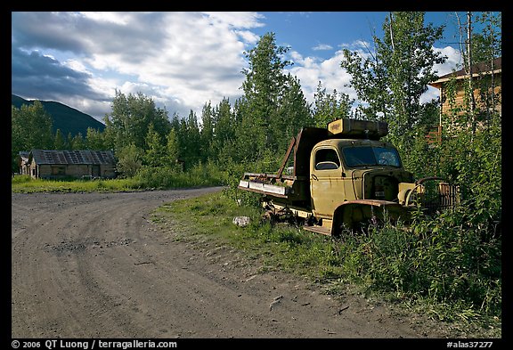 Side street with wrecked truck. McCarthy, Alaska, USA (color)