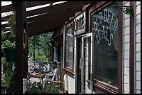 Man sitting in front of McCarthy lodge. McCarthy, Alaska, USA