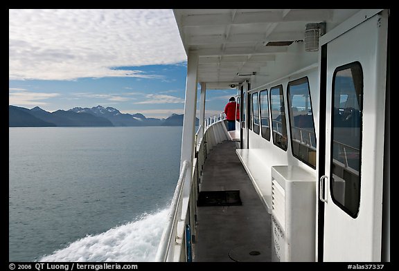 Passenger standing outside tour boat. Seward, Alaska, USA