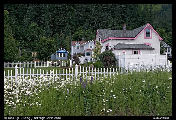 White picket fence and houses with pastel trims. Seward, Alaska, USA (color)