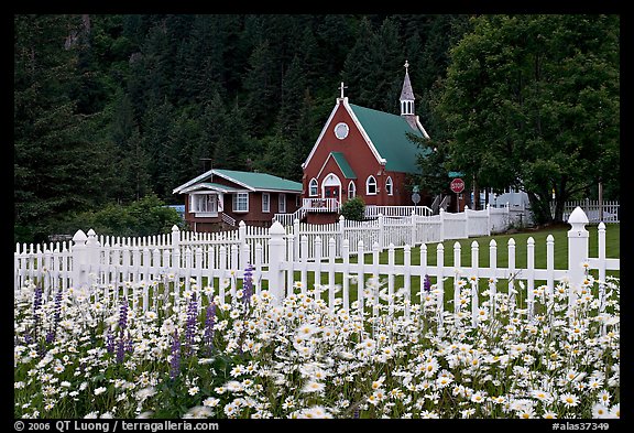 Flowers, white picket fence and church. Seward, Alaska, USA