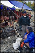 Inupiaq Eskimo man and woman next to fish hung for drying, Ambler. North Western Alaska, USA (color)