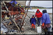 Inupiaq Eskimo family with stand of dried fish, Ambler. North Western Alaska, USA