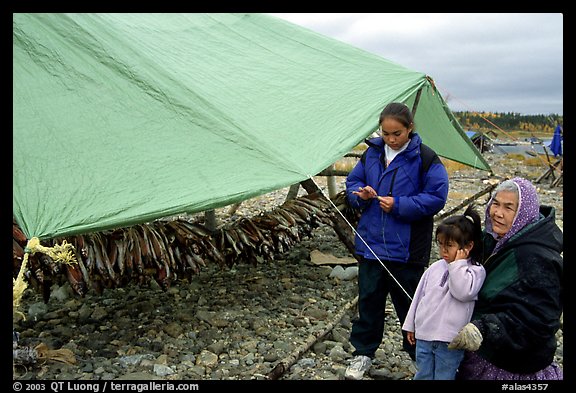 Inupiaq Eskimo family with stand of drying fish, Ambler. North Western Alaska, USA