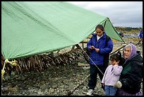 Inupiaq Eskimo family with stand of drying fish, Ambler. North Western Alaska, USA