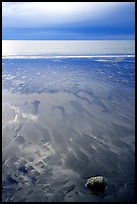 Sand patterns and stormy skies on the Bay. Homer, Alaska, USA