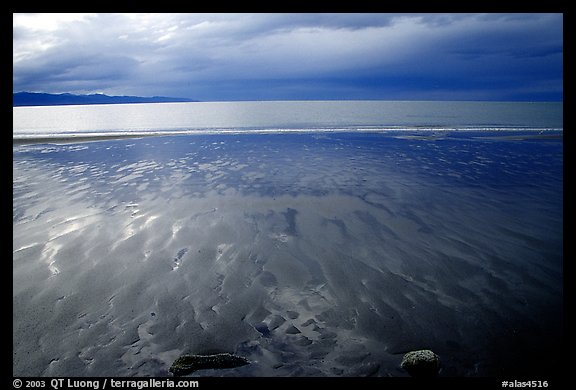 Sand patterns and stormy skies on the Bay. Homer, Alaska, USA (color)