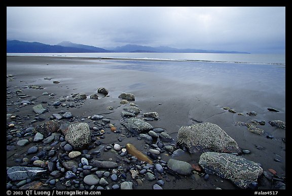 Sandy beach, rocks, and stormy skies on the Bay. Homer, Alaska, USA (color)