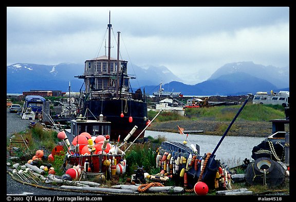 Retired fishing boat with a pile of marine gear on the Spit. Homer, Alaska, USA