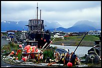 Retired fishing boat with a pile of marine gear on the Spit. Homer, Alaska, USA (color)