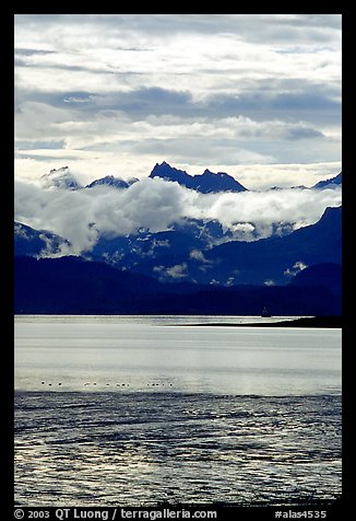 Low clouds hanging over Kenai Mountains across Katchemak Bay. Homer, Alaska, USA (color)