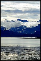 Low clouds hanging over Kenai Mountains across Katchemak Bay. Homer, Alaska, USA