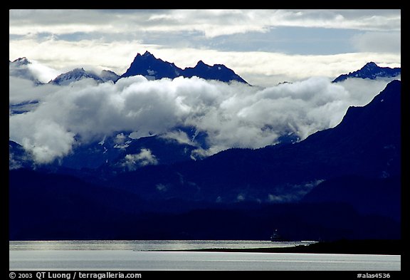 Mountains rising above bay with low clouds. Homer, Alaska, USA (color)