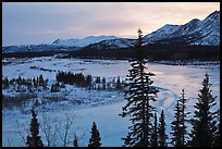 Winter landscape with frozen river at sunset. Alaska, USA (color)