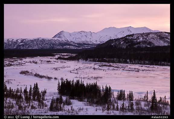 Frozen river and mountains at sunset. Alaska, USA