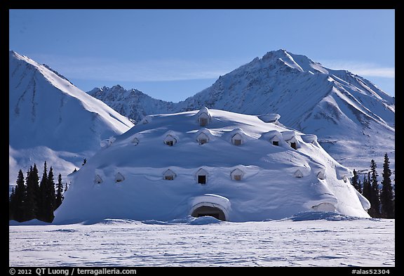 Snowy dome-shaped building and mountains. Alaska, USA