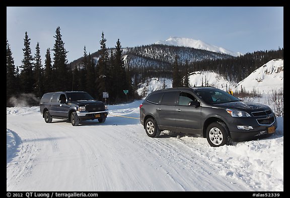 Car being pulled out of snowbank. Wiseman, Alaska, USA