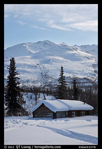 Snowy cabin and mountains. Wiseman, Alaska, USA