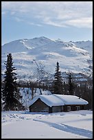 Snowy cabin and mountains. Wiseman, Alaska, USA