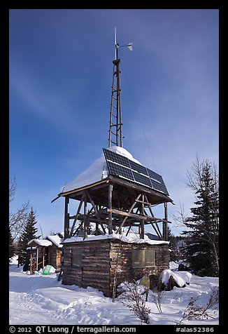 Tower with solar panels and windmill. Wiseman, Alaska, USA