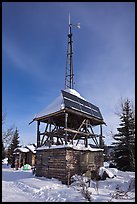 Tower with solar panels and windmill. Wiseman, Alaska, USA