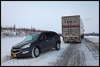 Commercial truck towing car, Dalton Highway. Alaska, USA ( color)