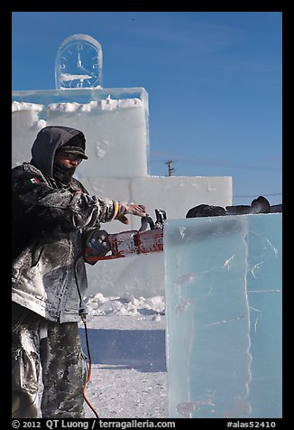 Sculptor using electric saw to carve ice. Fairbanks, Alaska, USA