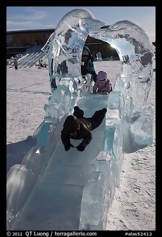 Children slide through ice sculpture. Fairbanks, Alaska, USA