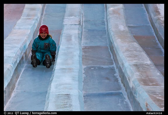 Girl on slide made of ice, George Horner Ice Park. Fairbanks, Alaska, USA