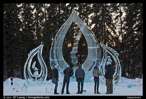 Tourists looking at ice sculpture, 2012 World Ice Art Championships. Fairbanks, Alaska, USA (color)