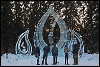 Tourists looking at ice sculpture, 2012 World Ice Art Championships. Fairbanks, Alaska, USA ( color)