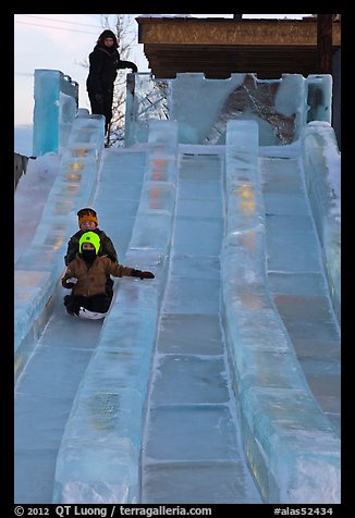 Lights come up inside ice slide at dusk. Fairbanks, Alaska, USA