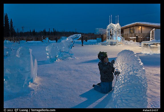 Child amongst ice sculptures at dusk. Fairbanks, Alaska, USA (color)