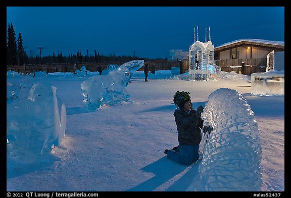 Child amongst ice sculptures at dusk. Fairbanks, Alaska, USA (color)