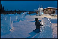 Child amongst ice sculptures at dusk. Fairbanks, Alaska, USA (color)