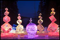 Balancing cubes made of ice at night, World Ice Art Championships. Fairbanks, Alaska, USA