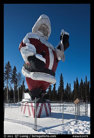 Santa Claus statue surrounded by barbed wire. North Pole, Alaska, USA (color)