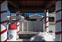 Bus stop with red candy-like stripped columns. North Pole, Alaska, USA