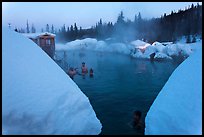 Soaking in natural hot pool surrounded by snow. Chena Hot Springs, Alaska, USA