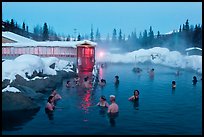 People soaking in outdoor hot springs pool in winter. Chena Hot Springs, Alaska, USA (color)