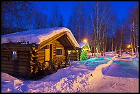 Path in snow and cabins at night. Chena Hot Springs, Alaska, USA