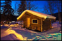 Snowy log cabin at night. Chena Hot Springs, Alaska, USA (color)