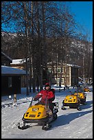 Snomobiler next to resort buildings. Chena Hot Springs, Alaska, USA ( color)