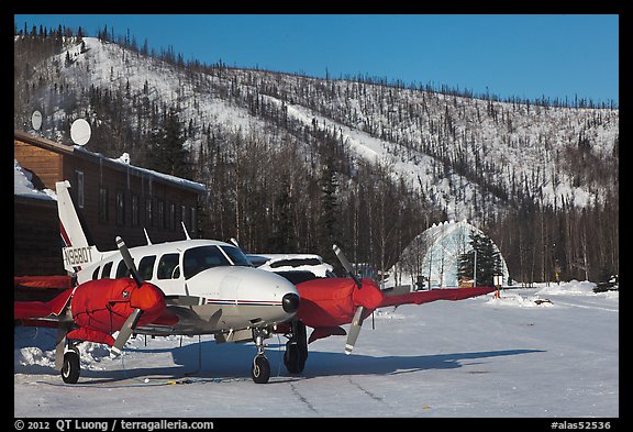 Plane with engine block warmers on frozen runway. Chena Hot Springs, Alaska, USA (color)