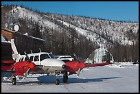 Plane with engine block warmers on frozen runway. Chena Hot Springs, Alaska, USA (color)