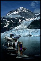 Kayakers unloading from the water taxi at Black Sand Beach. Prince William Sound, Alaska, USA